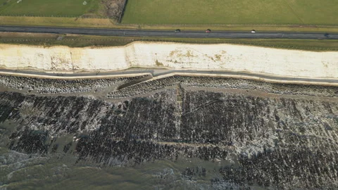 A high angle shot of white cliffs on the coastline. Stock Footage 274996828