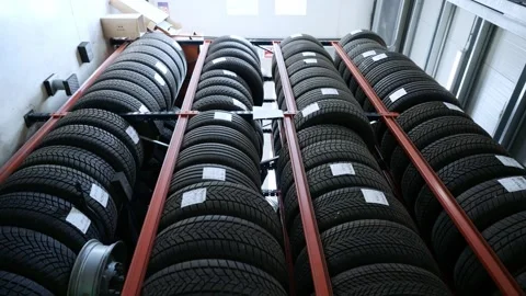 High Angle Shot of Winter Tires Stacked on High Red Shelving Stock Footage 318309575