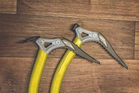 A high angle shot of yellow tools on a wooden surface ready to be picked up a Photos