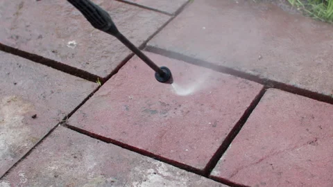 High angle slow motion shot of cleaning a flagstone with high pressure Vídeos de archivo 242017088