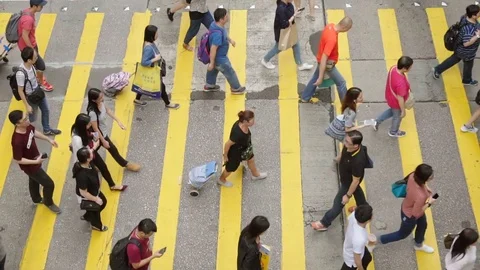 High angle slow motion video of pedestrians crossing a crosswalk in Hong Kong Stock Footage 79937872
