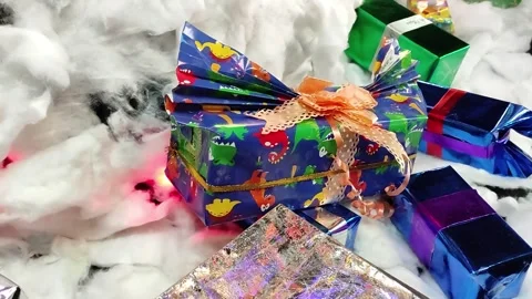 High angle Stacks of Christmas gift boxes with dinosaur decorations Stock Footage 265595689