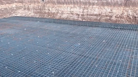 High-angle static view of a large building construction site trench showcasing Vídeos de archivo 335938890
