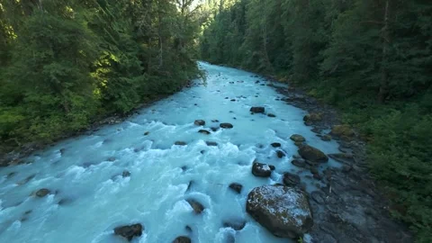 High angle stationary drone view overlooking a winding milky turquoise rive.. Stock-Footage 342765439
