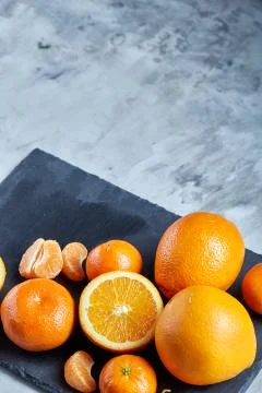 High angle still life view of sliced ruby orange and tangerine arranged together Stock Photos