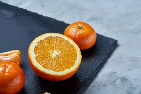 High angle still life view of sliced ruby orange and tangerine arranged together Stock Photos