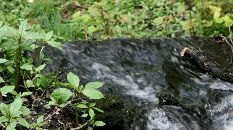 High angle stream tumbling over edge two thirds Video stock 22111240