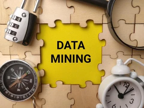 A high-angle studio shot featuring the text DATA MINING on a bright yellow .. Stock Photos