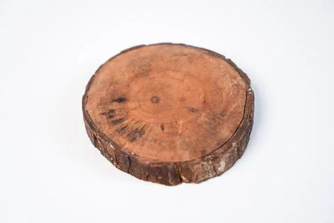 A high-angle studio shot featuring a single circular wooden log slice coast.. Stock Photos
