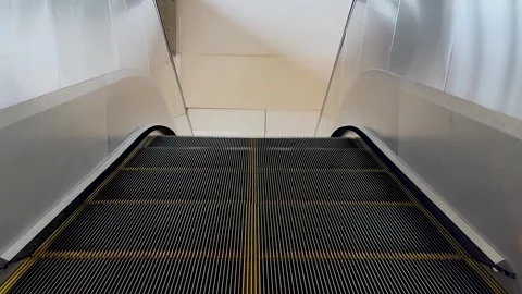 High angle symmetric shot of an empty escalator moving down in a modern pub.. Stock Footage 337583792