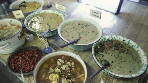 High angle table view of various condiments, sauces, and small side bowls Stock Footage 336286864