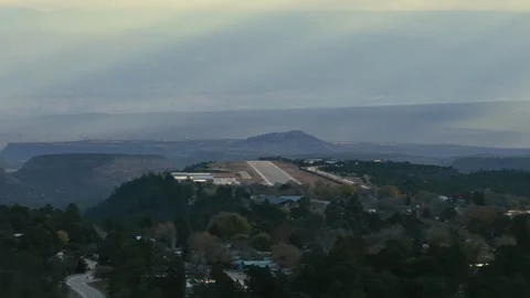 High-Angle Telephoto Orbit of Los Alamos Airport Runway with Dramatic Canyon Stock Footage 321529372