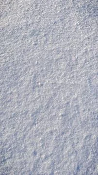High angle texture of fresh white snow surface with fine crystalline grains.. Stock Photos