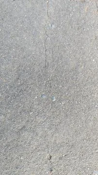 High Angle Texture of Weathered Asphalt Pavement with Fine Sand and Cracks Foto stock
