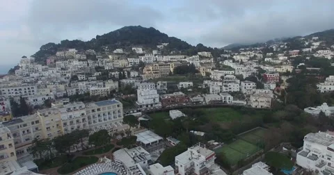 HIGH ANGLE TILT SHOT OF COASTLINE CLIFFS TO TOURIST CITY OF CAPRI IN ITALY Stock Footage 62740372