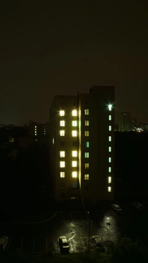 High angle time lapse of multi story residential building windows turning o.. Stock Footage 345581832
