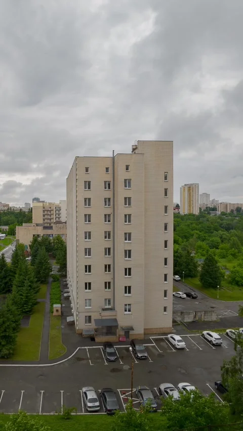 High angle time lapse of storm clouds moving over multi story residential b.. Stock Footage 345581771