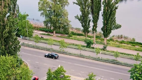 High angle timelapse of city traffic on a scenic road near a river canal Stock Footage 335576567