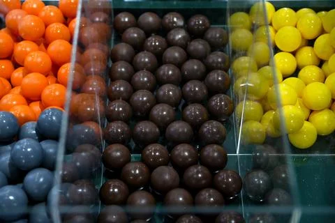 A high-angle, top-down view of rows of colorful, glossy round gumball candi.. Stock Photos