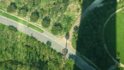 High angle top look down tower green park walkers cyclists Stock Footage 233479219