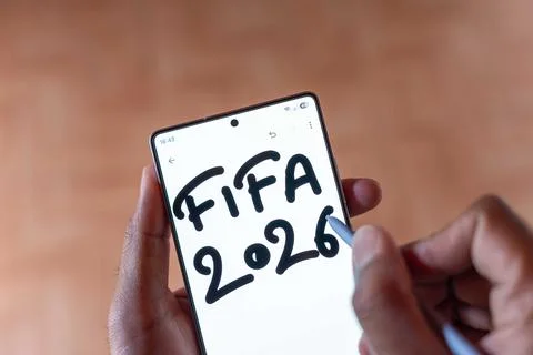 High Angle Top View of Hand Using Stylus to Write FIFA 2026 on Smartphone. Stock Photos