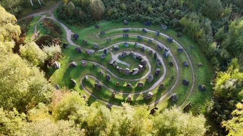 High-Angle Tracking Shot of the 81-Stone Spiral Landmark in the the Highlands Stock Footage 330667442