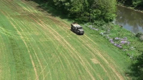A High Angle Tracking Shot of a Large Manure Truck Departing a Field Stock-Footage 197446729