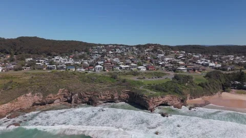 High Angle Tracking of Suburb and Ocean Beyond Headland Stock Footage 318155429