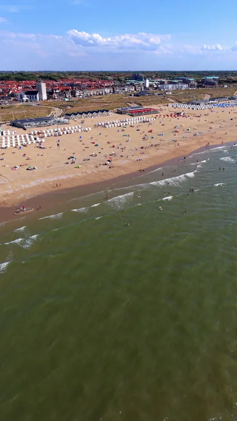 High angle vertical aerial drone video clip of sandy beach with beachgoers Stock Footage 342637348