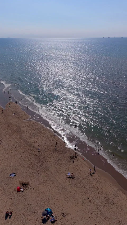 High angle vertical aerial drone video clip of sandy beach with beachgoers Stock Footage 342637418