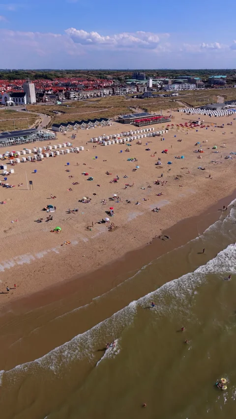 High angle vertical aerial drone video clip of sandy beach, beach cabins 스톡 동영상 343137437
