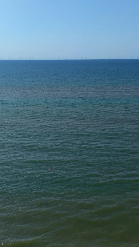 High angle vertical aerial drone video clip of North Sea water, swimmers Vídeos de archivo 343141231