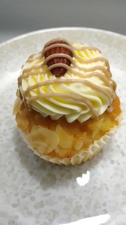High Angle Vertical Video of a Salted Caramel Drizzle Cupcake Stock Footage 327554354