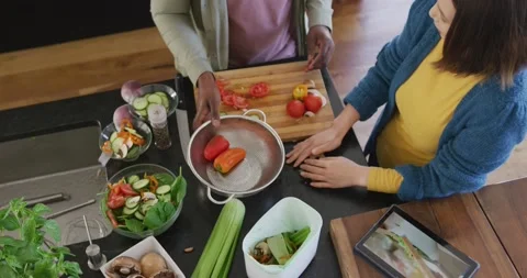 High angle video of diverse couple preparing food using tablet and composting Stock Footage 219899415