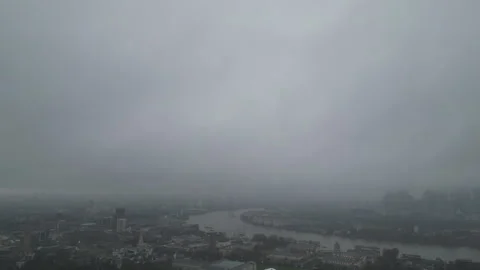 High angle video footage of Thames River and central London hidden in the fog. Stock Footage 300527084