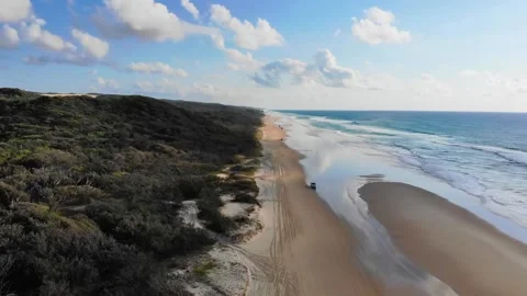 High angle view of 4WD driving throw the infinite beach in Fraser Island Stock Footage 196009212
