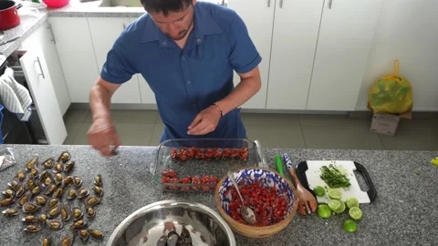 High angle view from above serving with a spoon various mussels a la chalaca Stock Footage 192890092