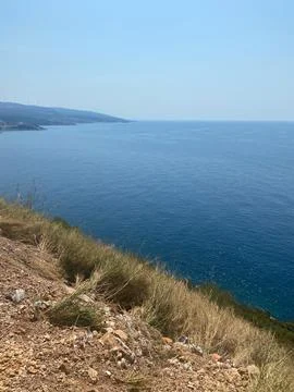 High-angle view of the Adriatic Sea from a dry grassy coastline in Montenegro Stock Photos