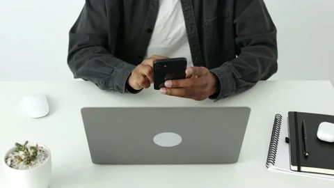 High angle view of African american man typing on smartphone, crypto enthusiast Stock Footage 196127106
