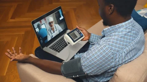 High angle view of african man with blood pressure meter consulting doctor Stock Footage 168690539