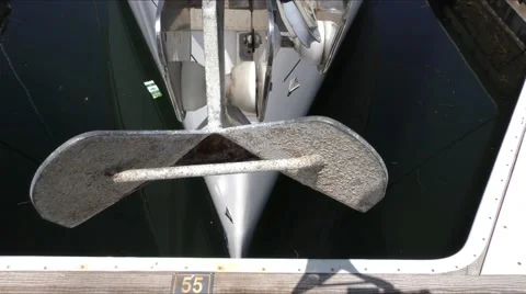 High angle view of anchor on bow of docked sailing yacht slowing moving in th Stock Footage 67517418