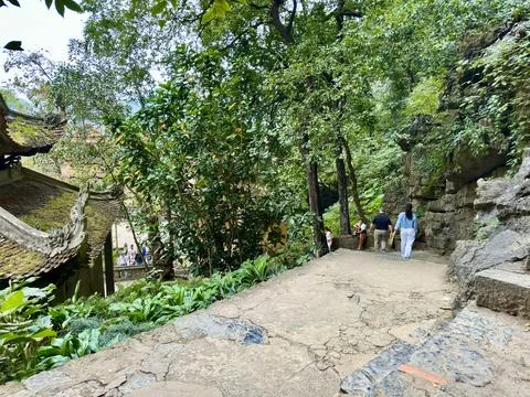 High angle view of the ancient mossy pagoda roof and the path among limestone Stock Photos
