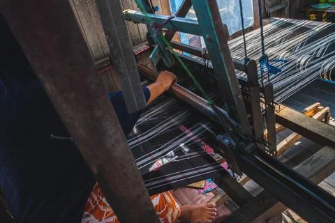 High angle view of artisan weaving traditional Sarung Samarinda on loom Stock Photos