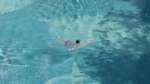 High angle view of Asian boy swimming in summer in slow motion Stock Footage 78190542