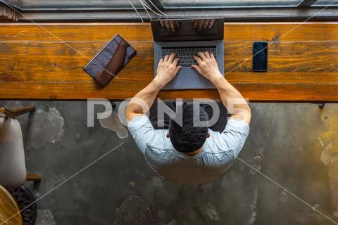 High angle view of Asian businessman working on laptop Stock Photos