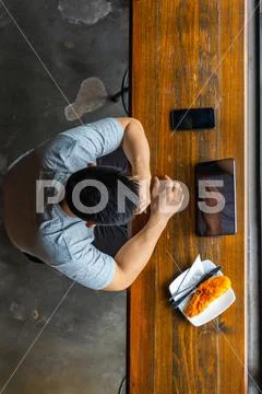 High angle view of Asian businessman using tablet next to smartphone Stock Photos