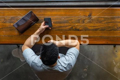 High angle view of Asian man using cellphone and tablet Stock Photos