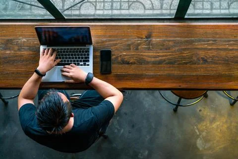 High angle view of Asian man using laptop Stock Photos