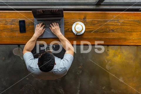 High angle view of Asian millennial working on laptop Stock Photos