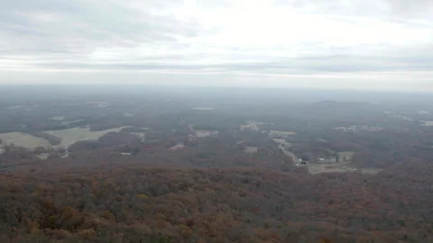 High Angle View of Autumn Forest and Rolling Hills Under Overcast Sky Stock Footage 343933895